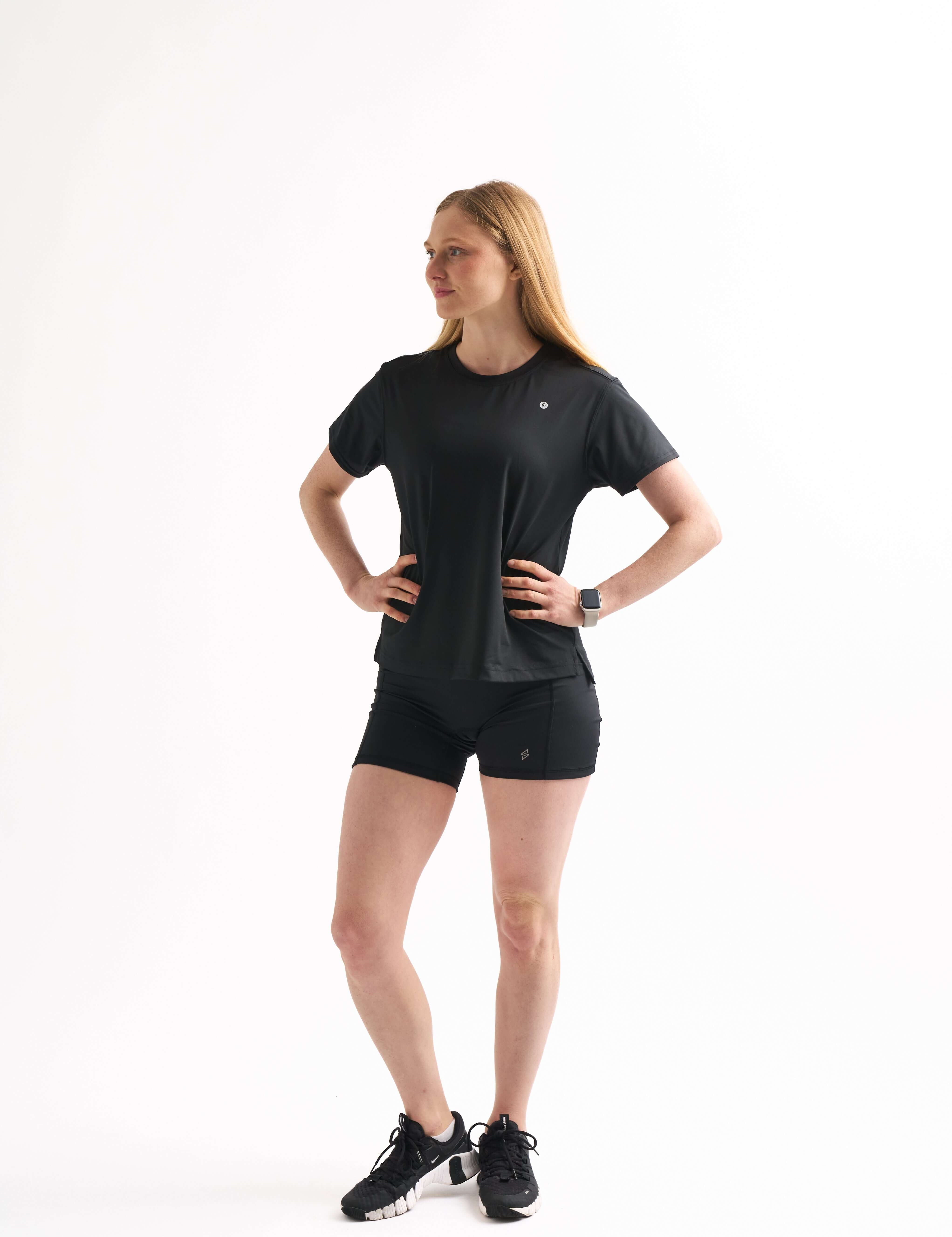 Woman in Flow State Relaxed Shortsleeve Top with hands on hips. A layering top that goes from warm-up to streetwear.