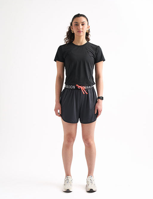 Woman wearing Locked In Running Shorts with a drawstring waist and breathable mesh fabric for ultimate comfort.