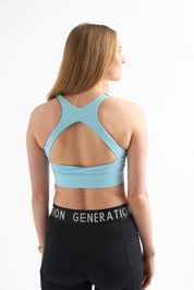 Back view of Power Moves Midrise Shorts paired with a blue Zero G sports bra.
