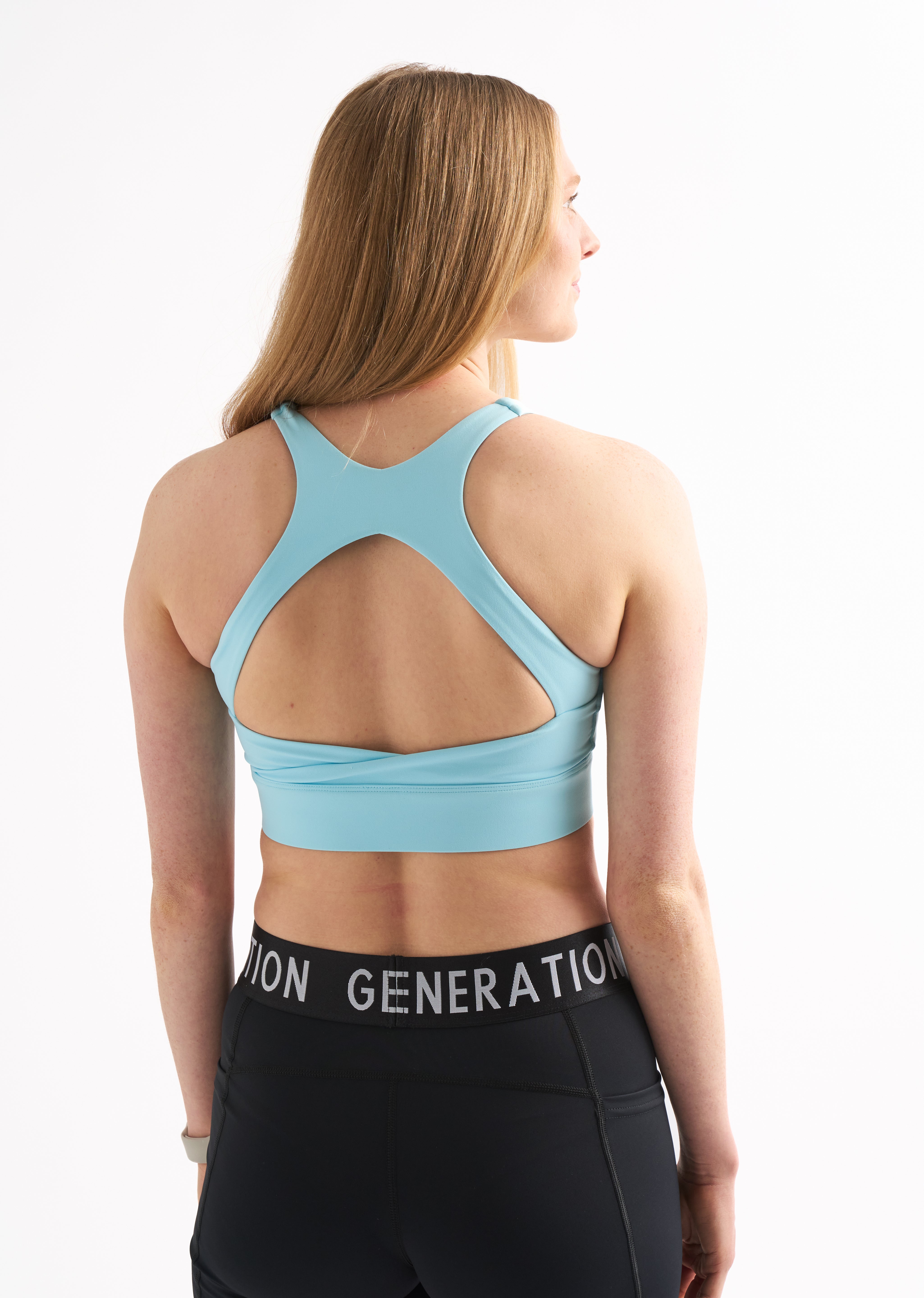 Back view of Power Moves Midrise Shorts paired with a blue Zero G sports bra.