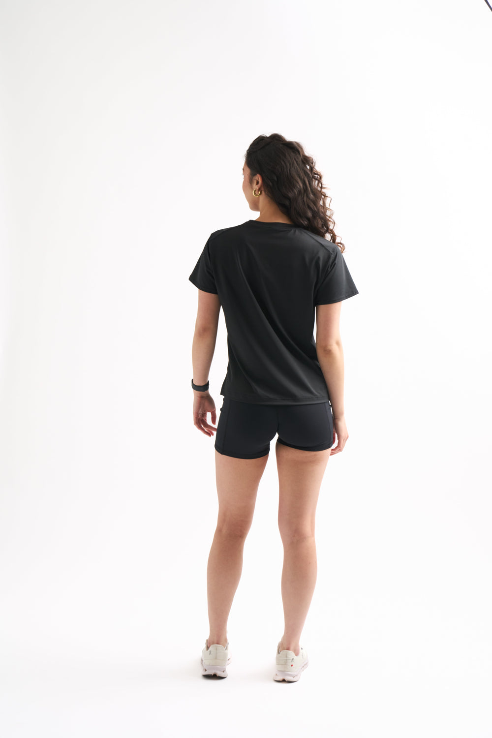 Woman looking away in the Flow State Relaxed Shortsleeve Top. Lightweight and comfortable for every workout.