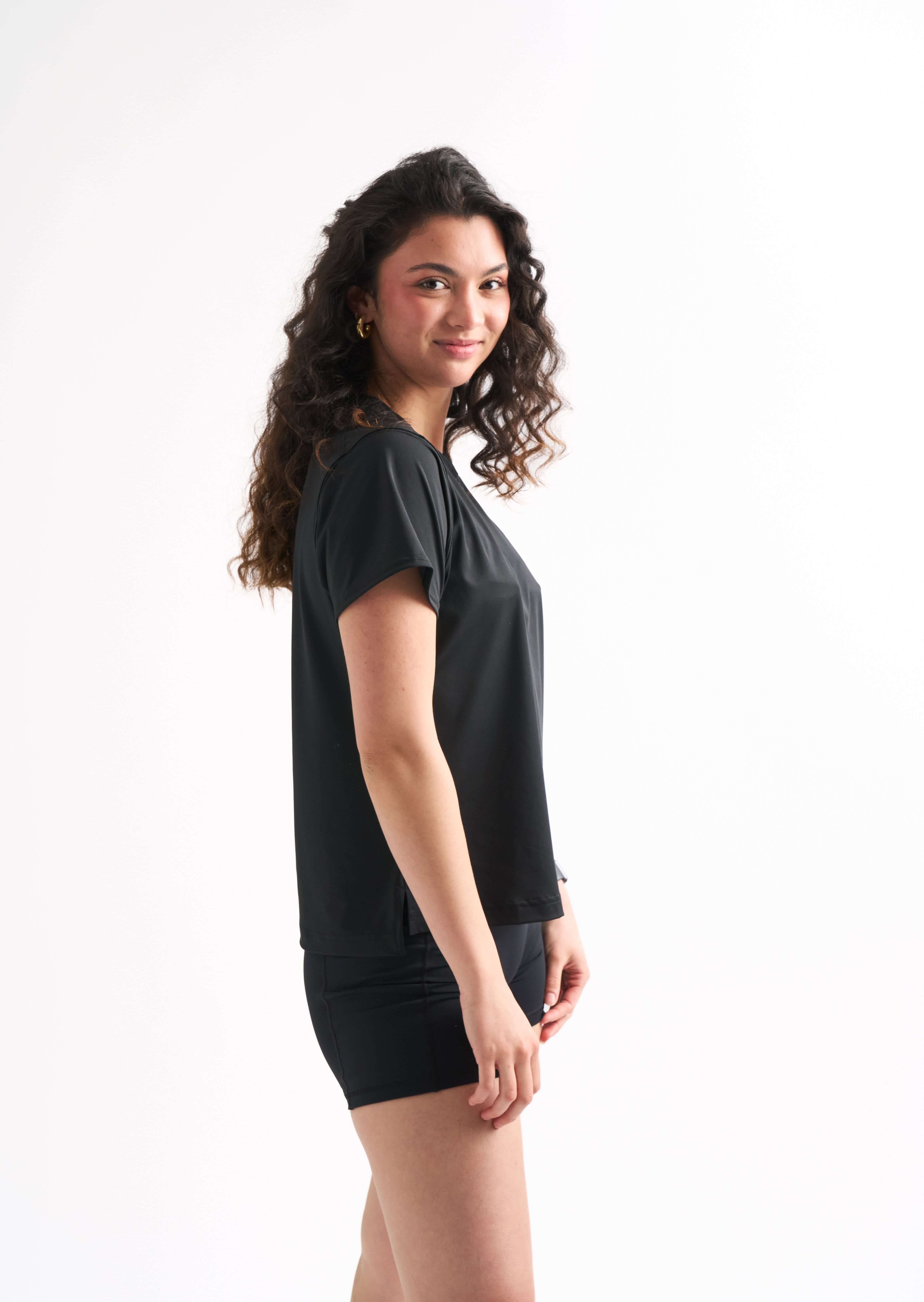 Side view of a woman wearing the Flow State top and bike shorts.