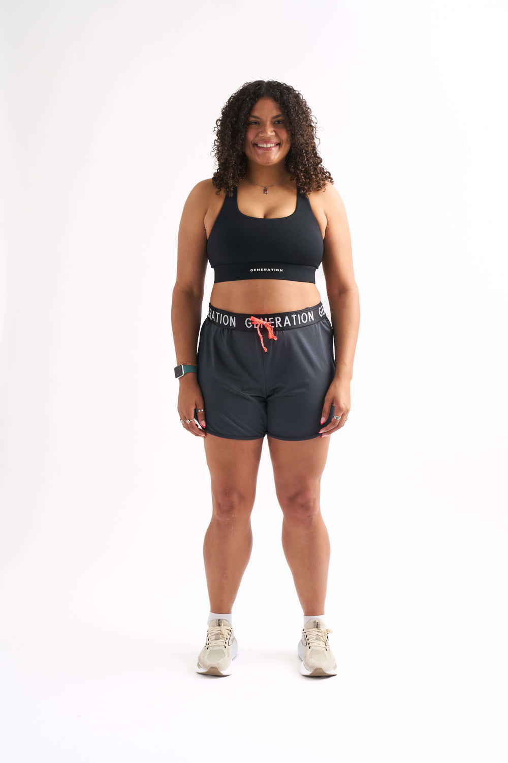 Woman wearing Locked In drawstring running shorts and sports bra with a stylish and comfortable look.