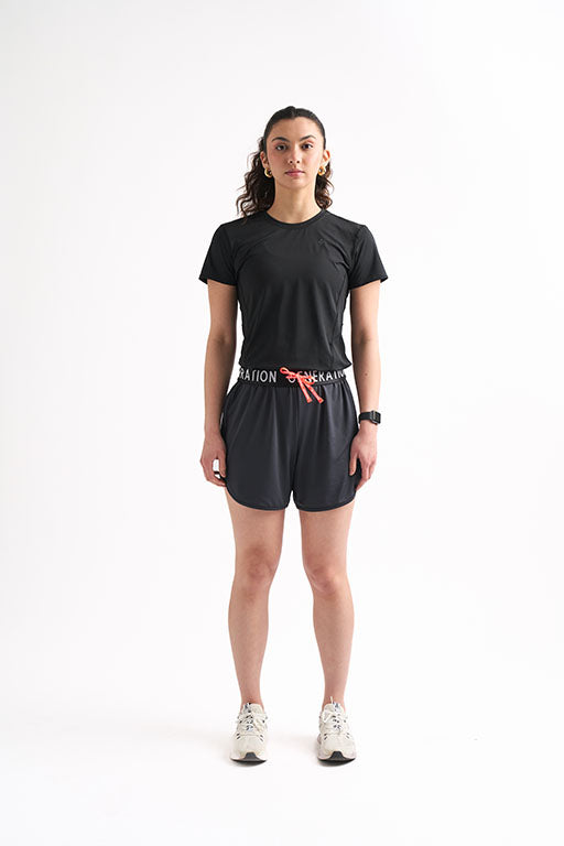 Woman wearing Locked In Running Shorts with a drawstring waist and breathable mesh fabric for ultimate comfort.